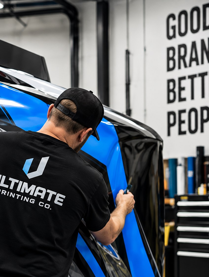 Installer applying a vehicle wrap